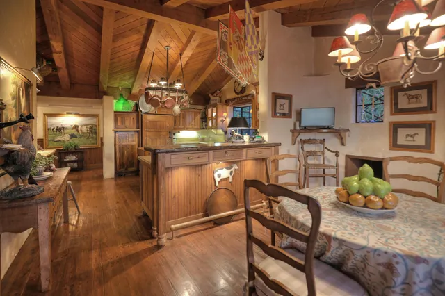 a view of a dining room with furniture a chandelier and wooden floor