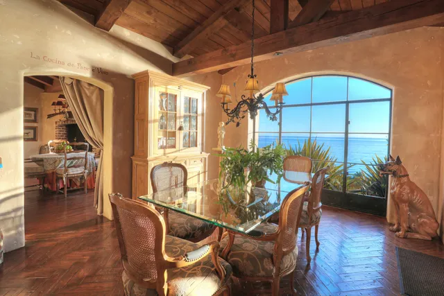 a dining room with furniture window and wooden floor