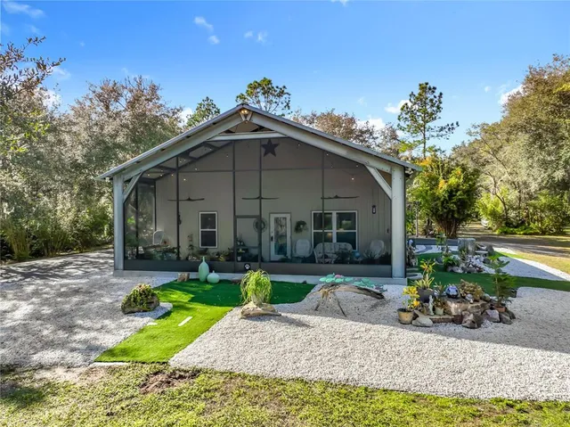 a view of a house with backyard porch and sitting area