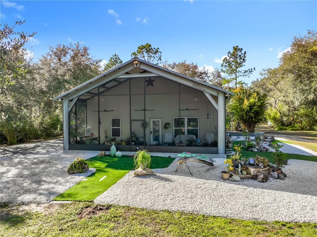 a view of a house with backyard porch and sitting area