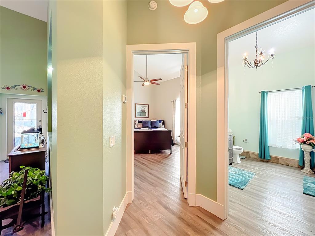 1825 Pams Way Geneva, FL 32732 - Photo 19 of 60 a view of a hallway with wooden floor and a living room