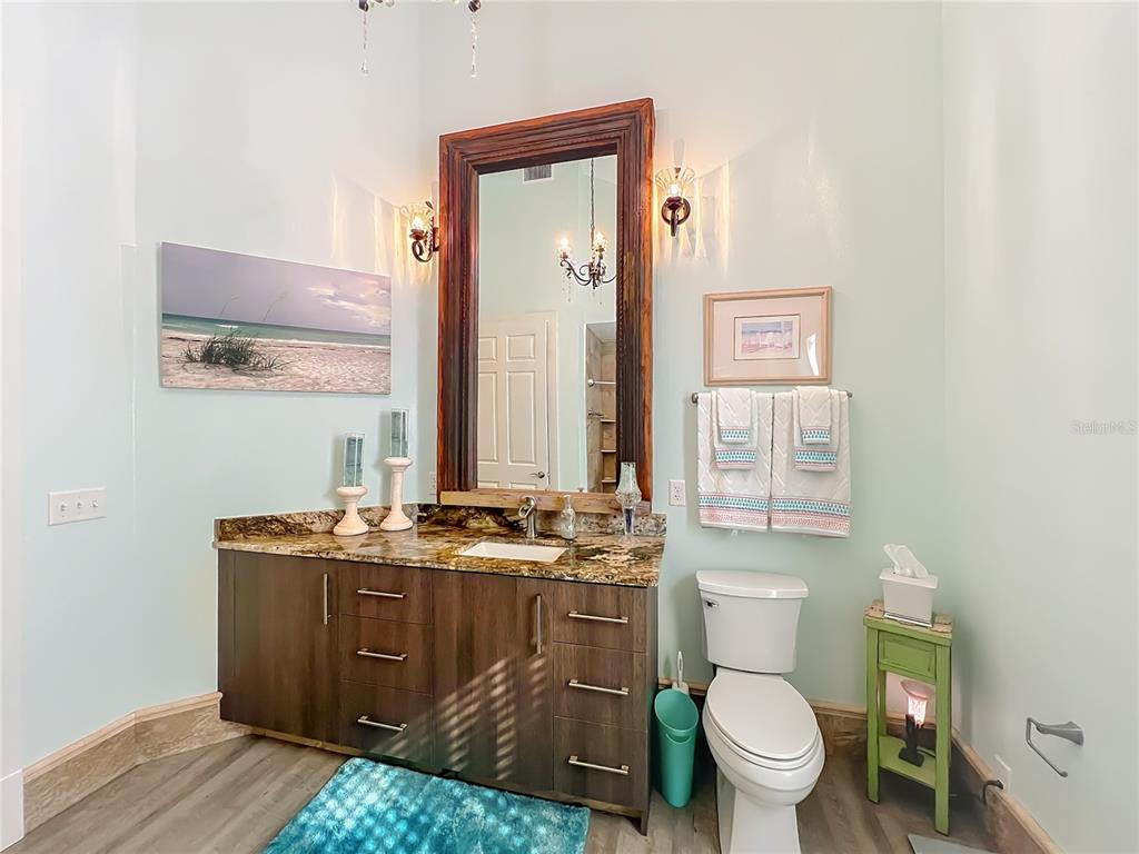 1825 Pams Way Geneva, FL 32732 - Photo 25 of 60 a bathroom with a granite countertop toilet sink and mirror