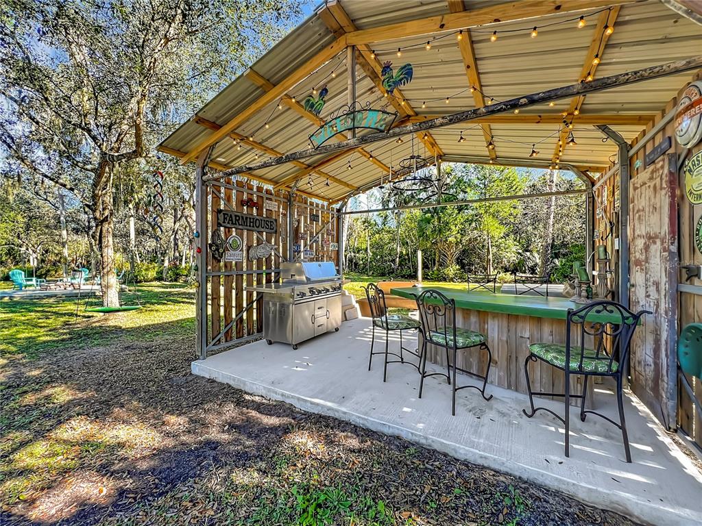 1825 Pams Way Geneva, FL 32732 - Photo 35 of 60 a view of a patio with a table chairs and a yard