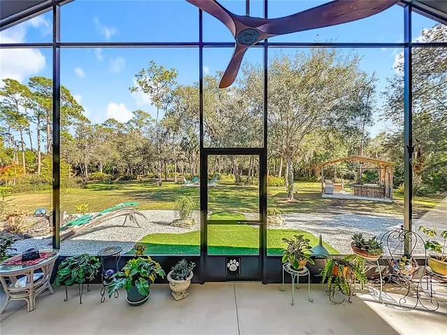 a living room with furniture a fireplace and a chandelier