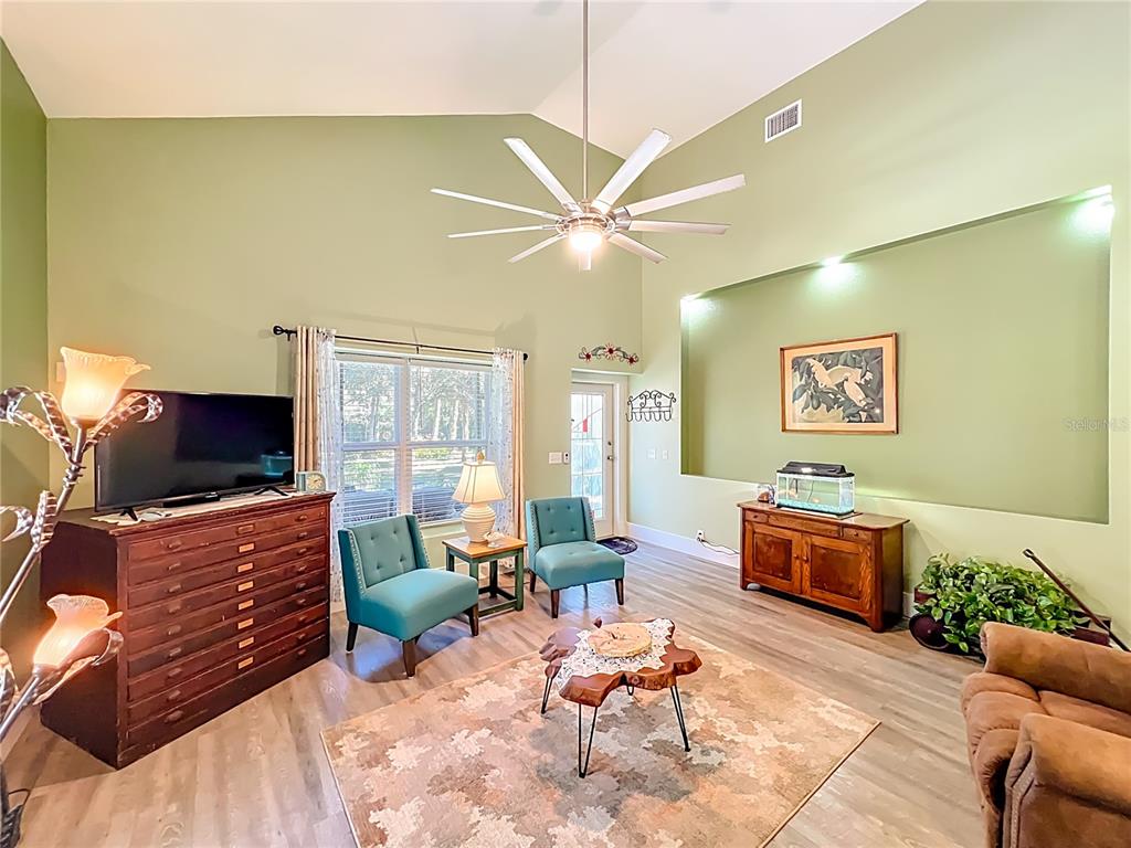 1825 Pams Way Geneva, FL 32732 - Photo 8 of 60 a living room with furniture and a flat screen tv