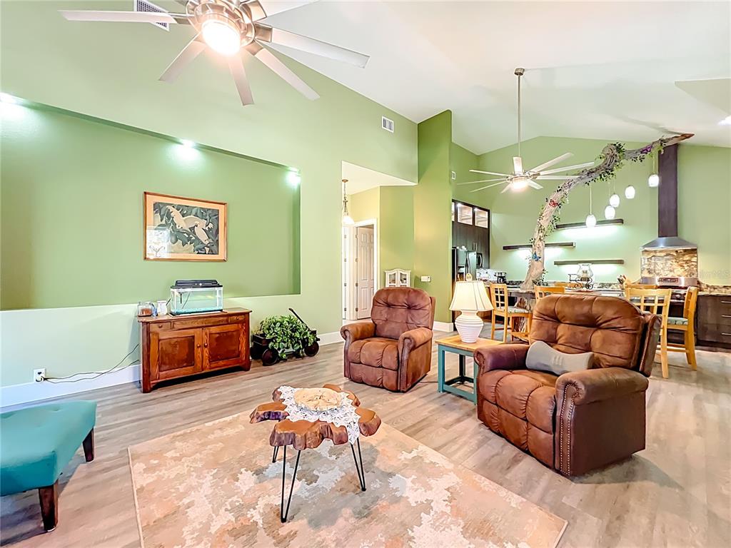 1825 Pams Way Geneva, FL 32732 - Photo 9 of 60 a living room with furniture and a chandelier