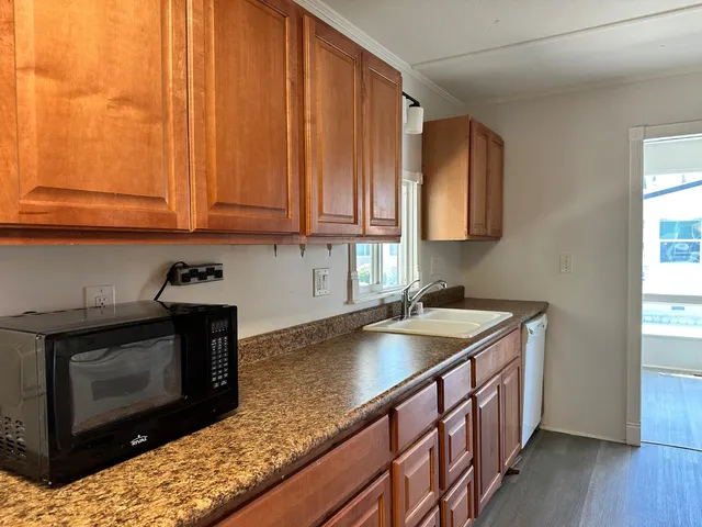 a kitchen with a refrigerator sink and cabinets