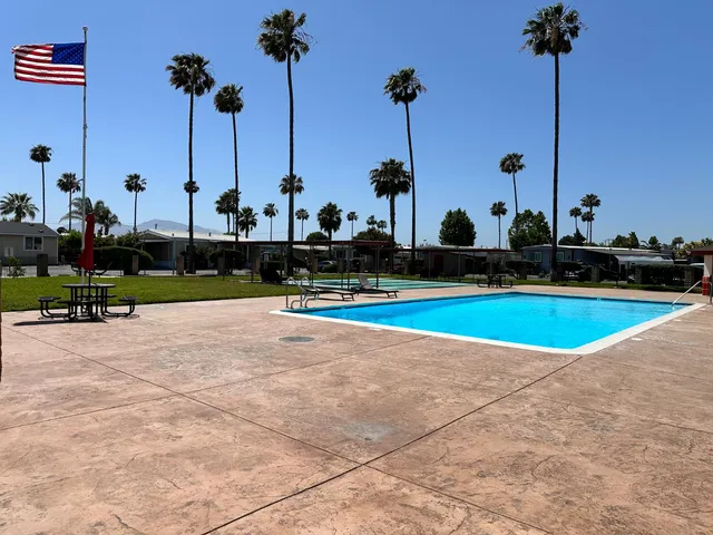 a view of a garden with tall buildings