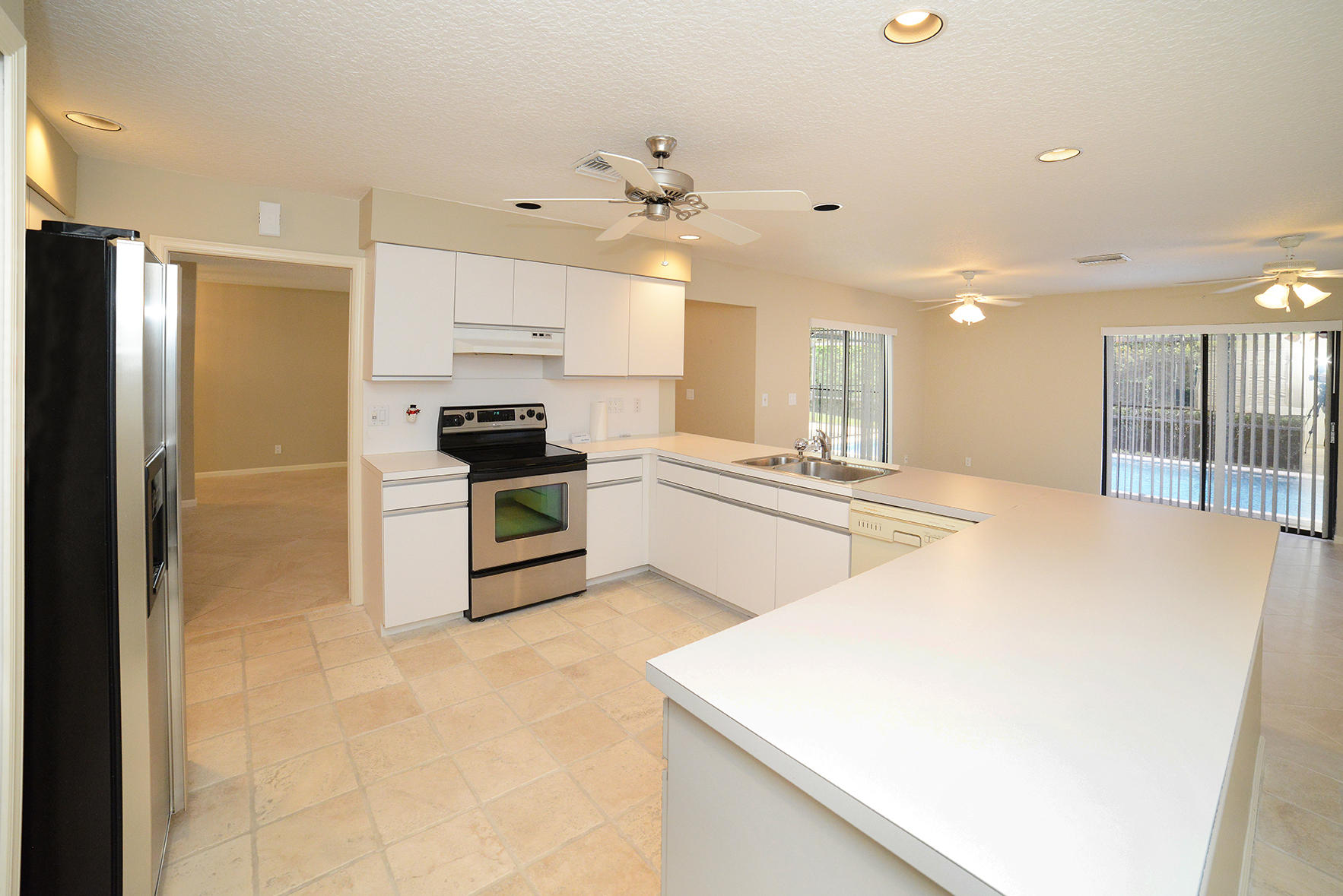 17290 Lake Park Road Boca Raton, FL 33487 - Photo 11 of 28 a kitchen with stainless steel appliances a refrigerator sink and stove
