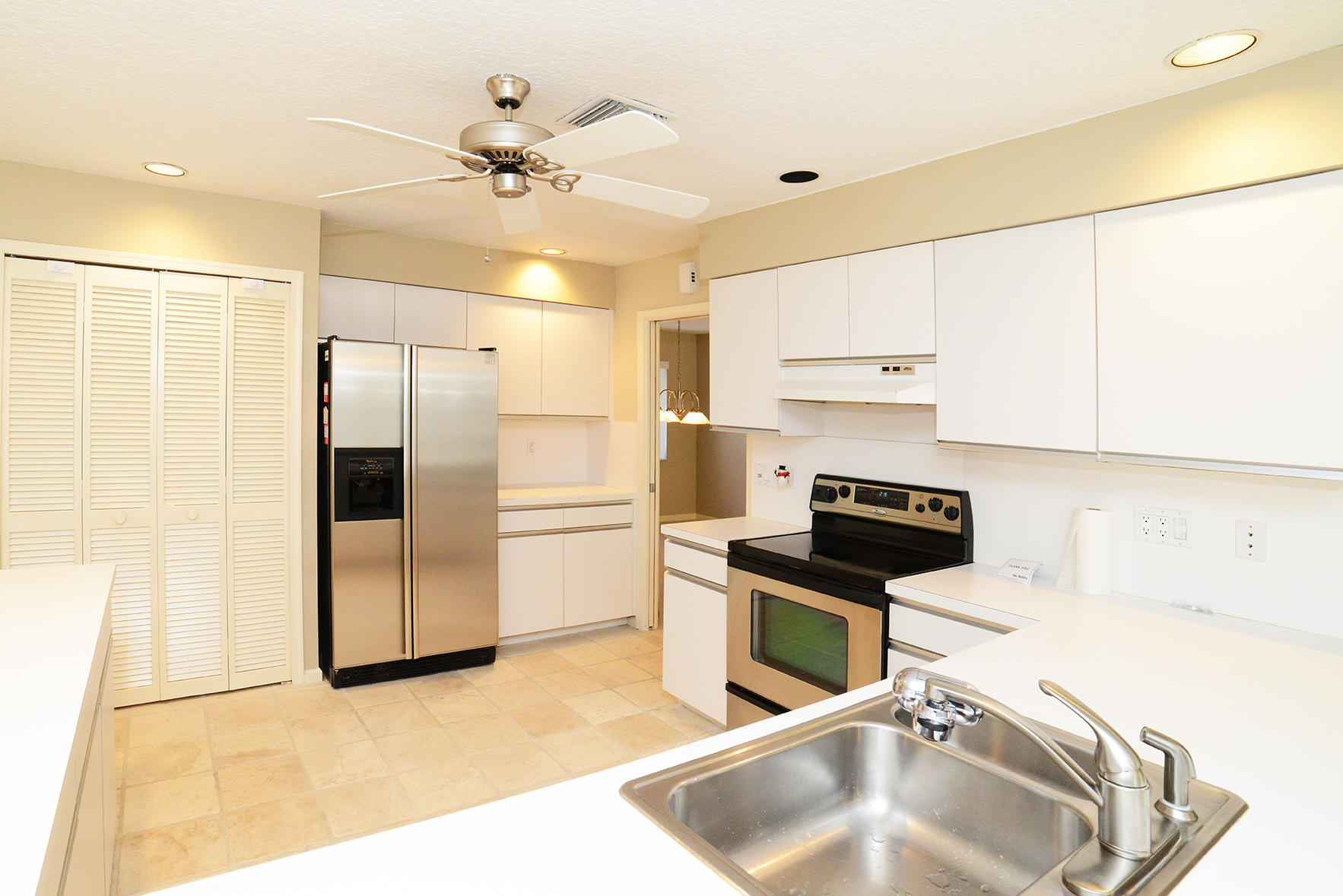 17290 Lake Park Road Boca Raton, FL 33487 - Photo 12 of 28 a kitchen with stainless steel appliances granite countertop a sink a stove and a refrigerator with cabinets