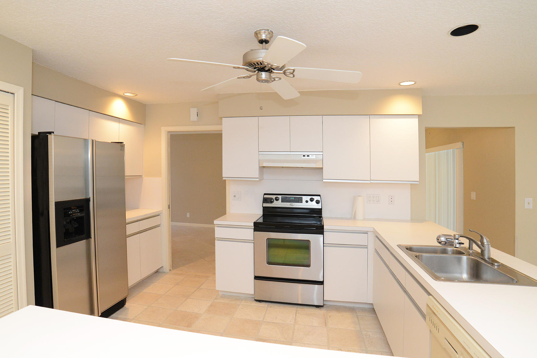 17290 Lake Park Road Boca Raton, FL 33487 - Photo 13 of 28 a kitchen with stainless steel appliances a stove a sink a refrigerator and cabinets