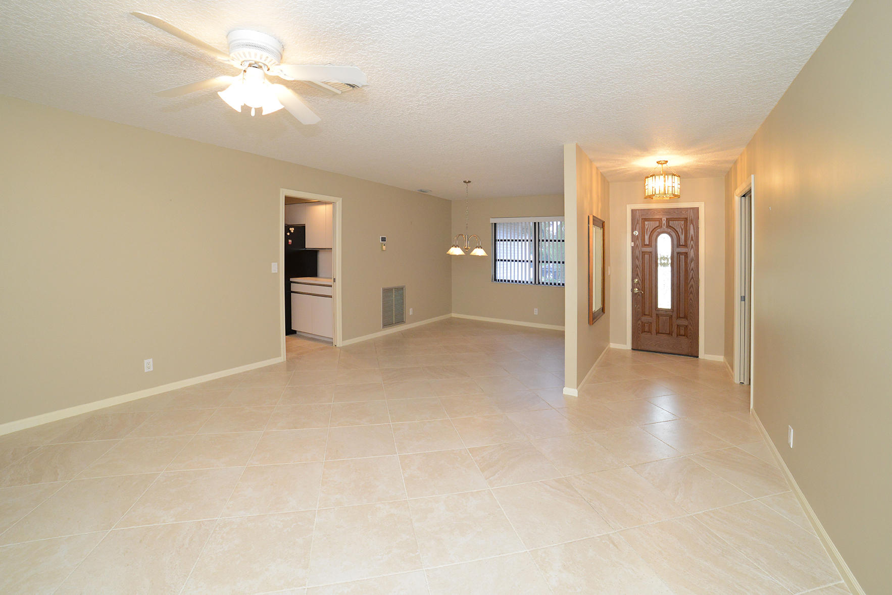 17290 Lake Park Road Boca Raton, FL 33487 - Photo 15 of 28 an empty room with fan and entrance