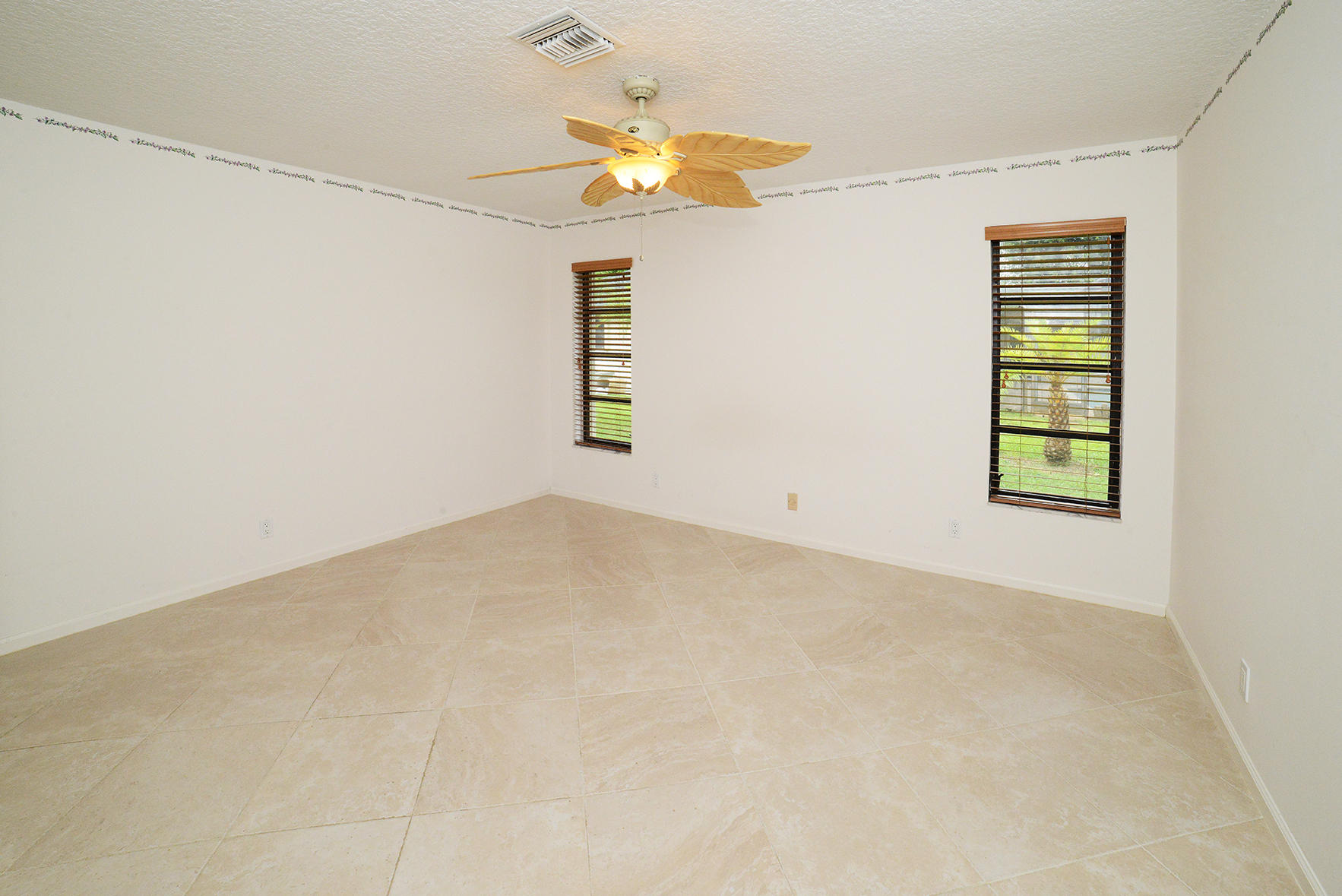 17290 Lake Park Road Boca Raton, FL 33487 - Photo 20 of 28 an empty room with a window and a ceiling fan