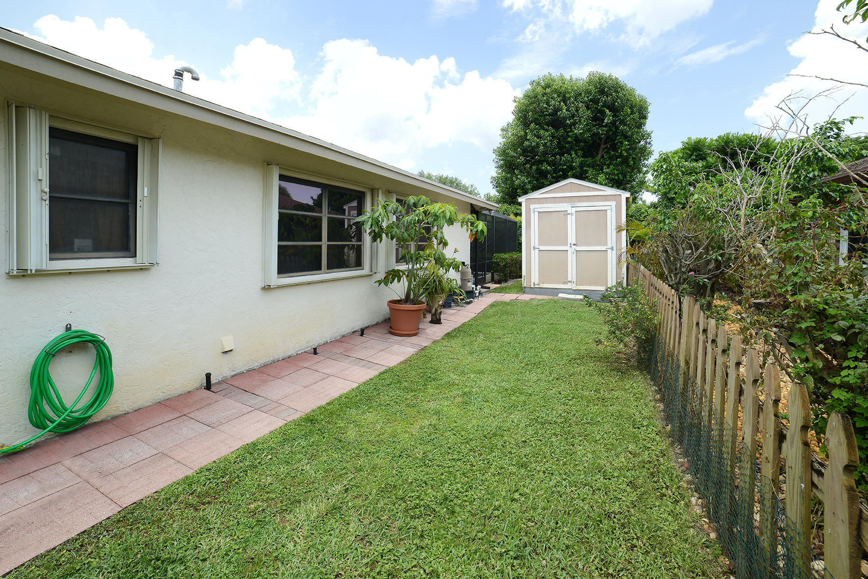 17290 Lake Park Road Boca Raton, FL 33487 - Photo 27 of 28 a front view of a house with garden