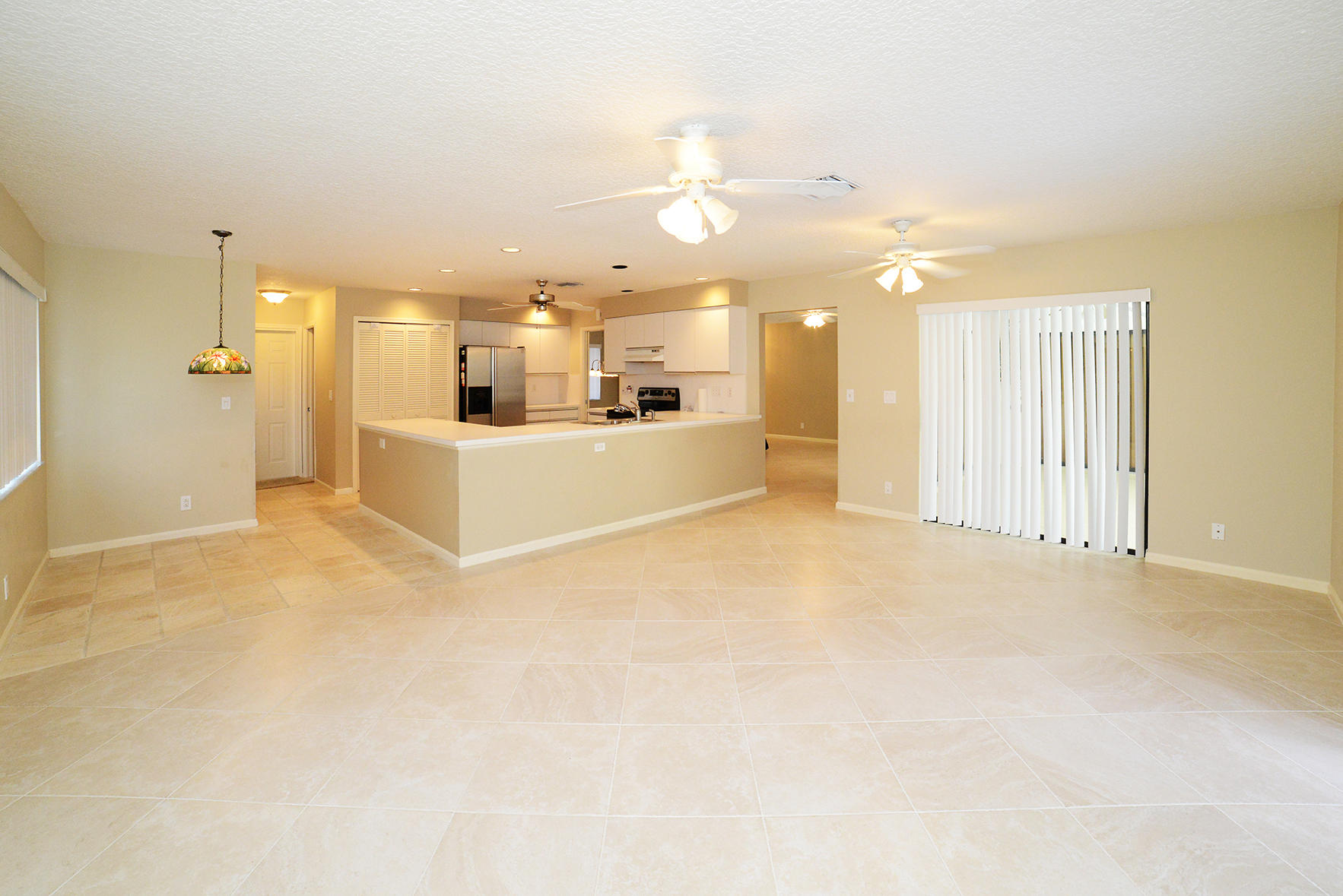 17290 Lake Park Road Boca Raton, FL 33487 - Photo 9 of 28 an empty room with a kitchen view and a window