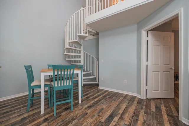 a view of a room with wooden floor and stairs