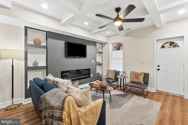 a living room with furniture a fireplace and a flat screen tv
