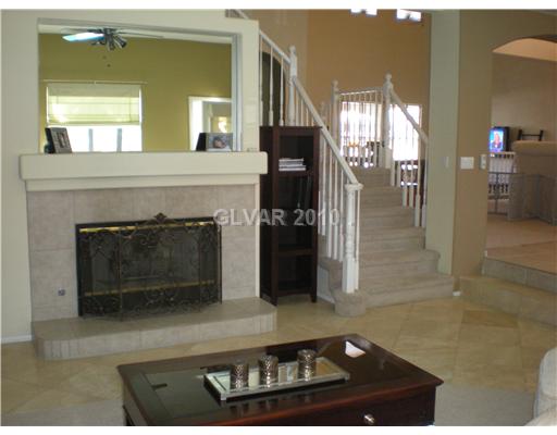 418 Rhythm Street Henderson, NV 89074 - Photo 6 of 22 Property Photo. Fireplace and stairs from family room