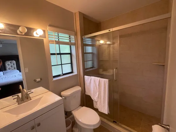 a white toilet sitting next to a bathroom sink