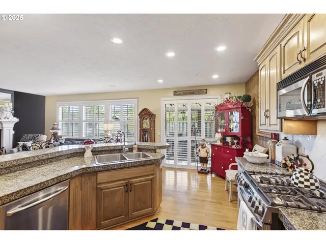 a kitchen with wooden cabinets a sink and stainless steel appliances