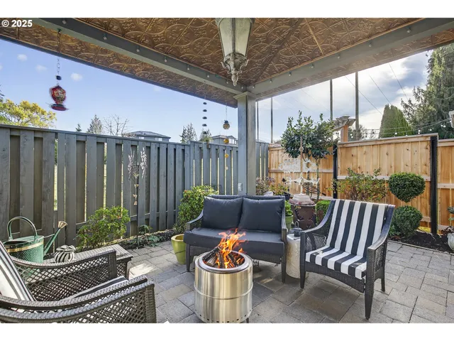a view of a patio with couches chairs and wooden floor