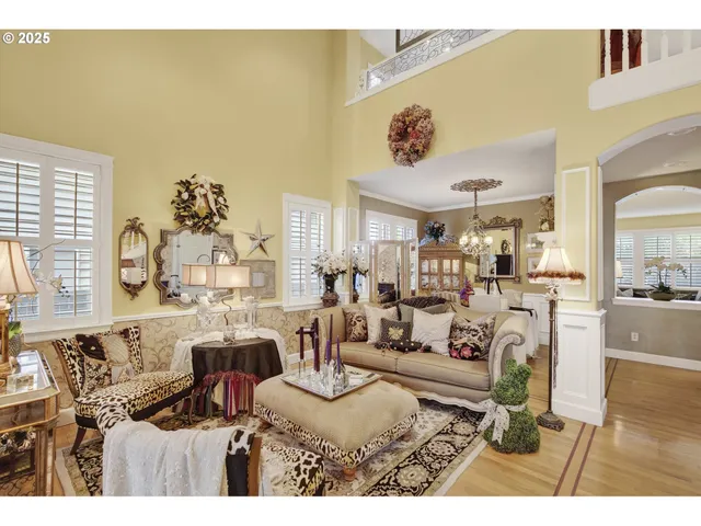 a living room with furniture and a chandelier