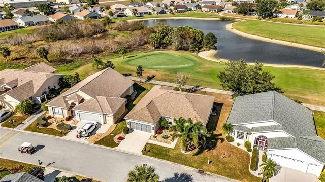 an aerial view of a house with garden space and lake view