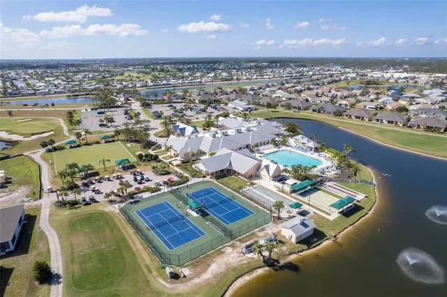 an aerial view of a house swimming pool and outdoor seating