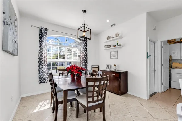 a view of a dining room with furniture and chandelier