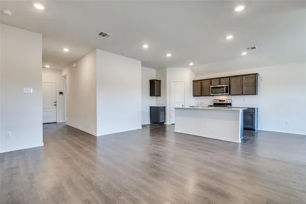 a view of kitchen with microwave and refrigerator