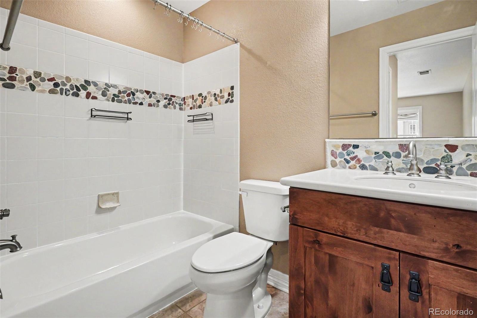 791 Elk Rest Road Evergreen, CO 80439 - Photo 29 of 46 a bathroom with a sink a toilet and shower