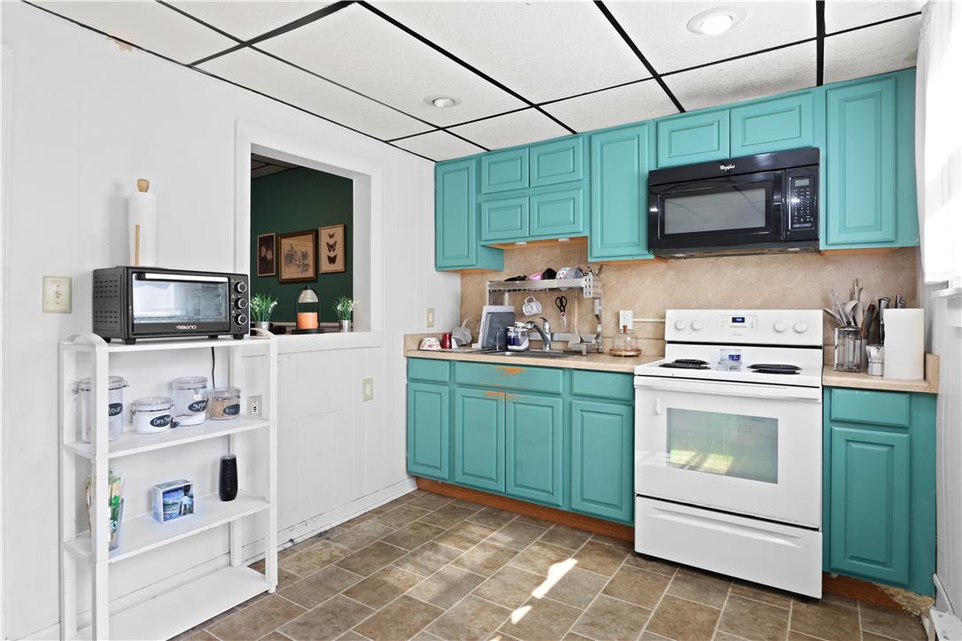 431 Pierce Street Bethlehem, PA 18015 - Photo 9 of 27 Bold turquoise cabinetry highlights a well-appointed kitchen featuring essential cooking appliances.