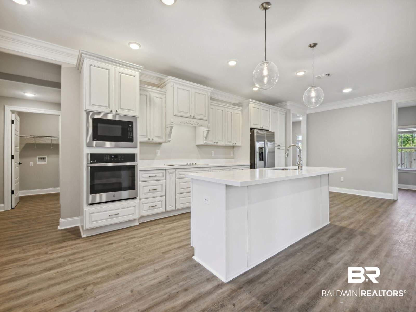 12943 Gondala Street Elberta, AL 36530 - Photo 4 of 23 Kitchen with appliances with stainless steel finishes, decorative light fixtures, recessed lighting, dark wood finished floors, and crown molding