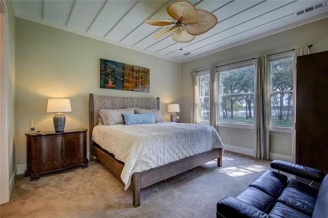 a bedroom with a bed couch and window