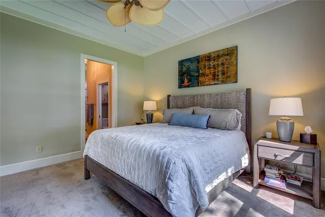 a bedroom with a bed and a lamp on table