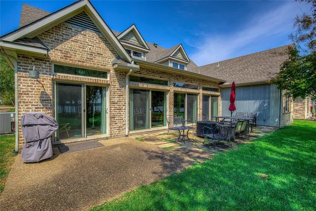 a front view of a house with patio and garden