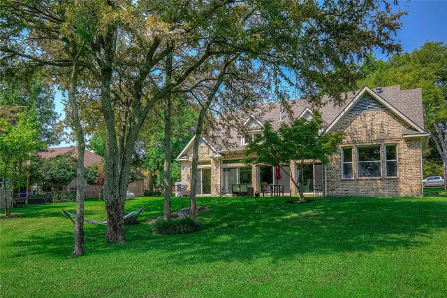a front view of house with a garden