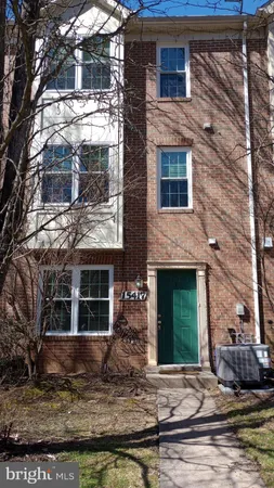 a view of a brick house with many windows