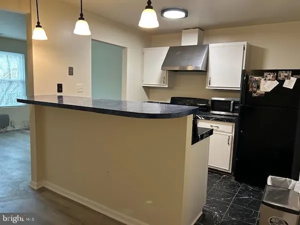 a kitchen with stainless steel appliances granite countertop a sink a stove and a refrigerator