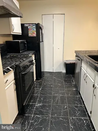 a kitchen with a stove and a refrigerator