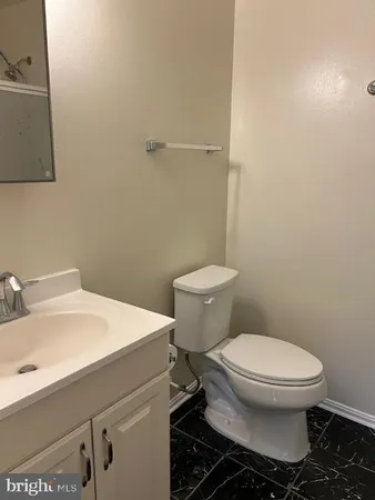 a bathroom with a sink toilet and a mirror
