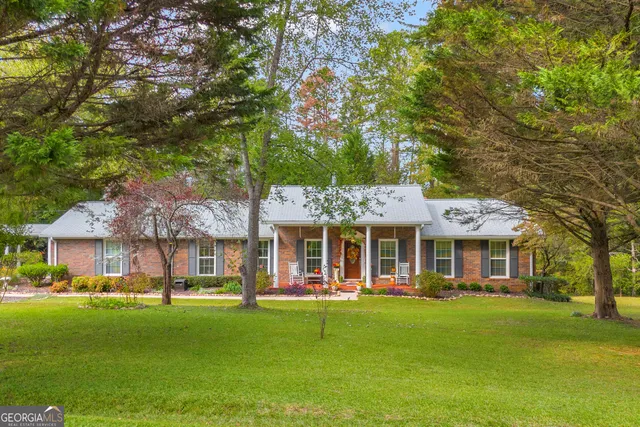 a front view of a house with a yard patio and swimming pool