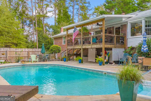 a dining room with furniture a flat screen tv and a window