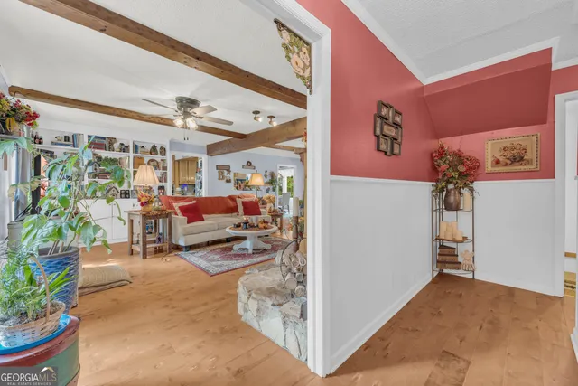 a dining room with furniture window and wooden floor