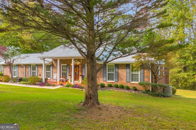 a front view of a house with a garden