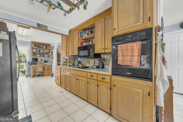 a bedroom with a large bed and a chandelier fan