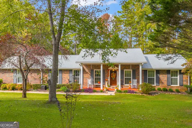 a car parked in front of a house with wooden fence