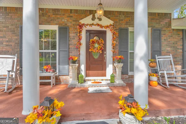 a living room with furniture and floor to ceiling windows