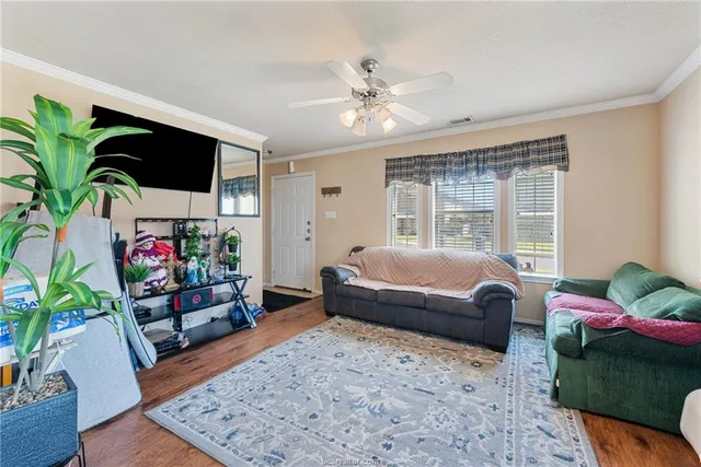 a bedroom with furniture and a flat screen tv