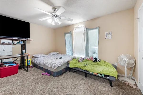 a bedroom with a bed and a flat screen tv